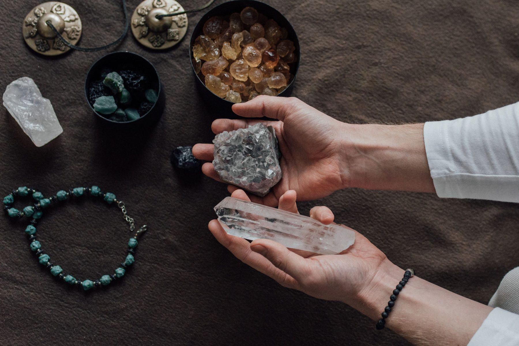 Hands holding healing crystals